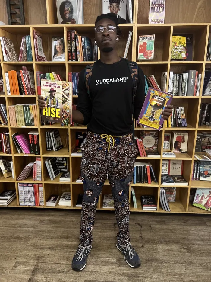 Customer with Black-owned cookbooks and spiritual reading at Nicholas Brooklyn