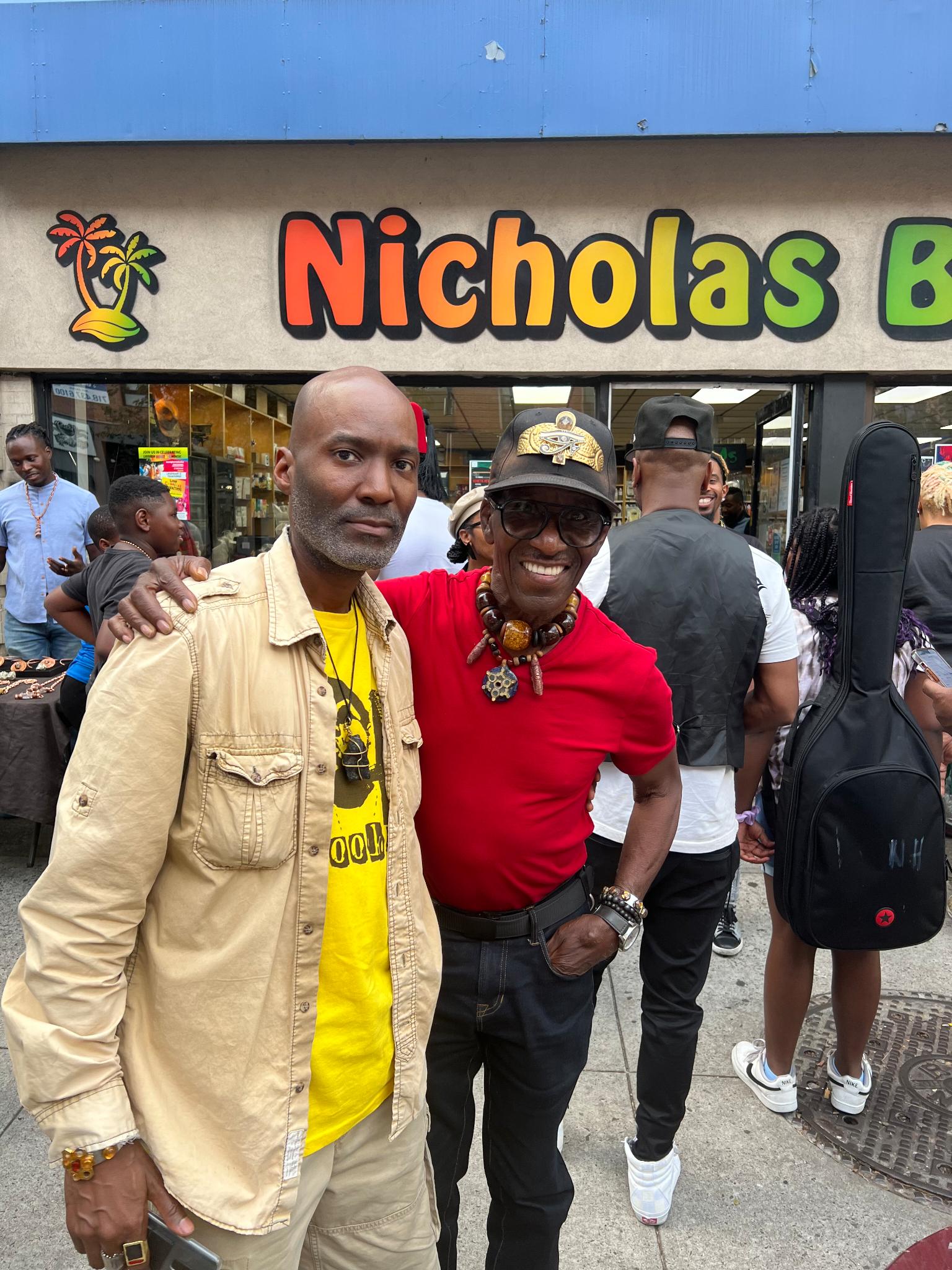 Friends reuniting outside the Nicholas Brooklyn storefront during a community event